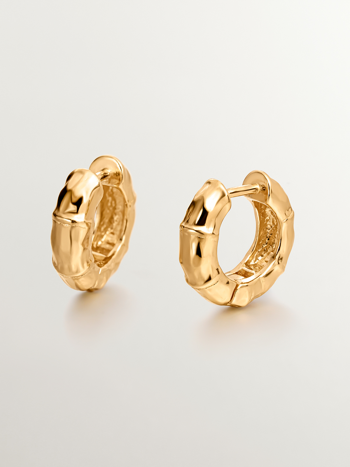 Small hoop earrings made of 925 silver, bathed in 18K yellow gold with a bamboo texture.