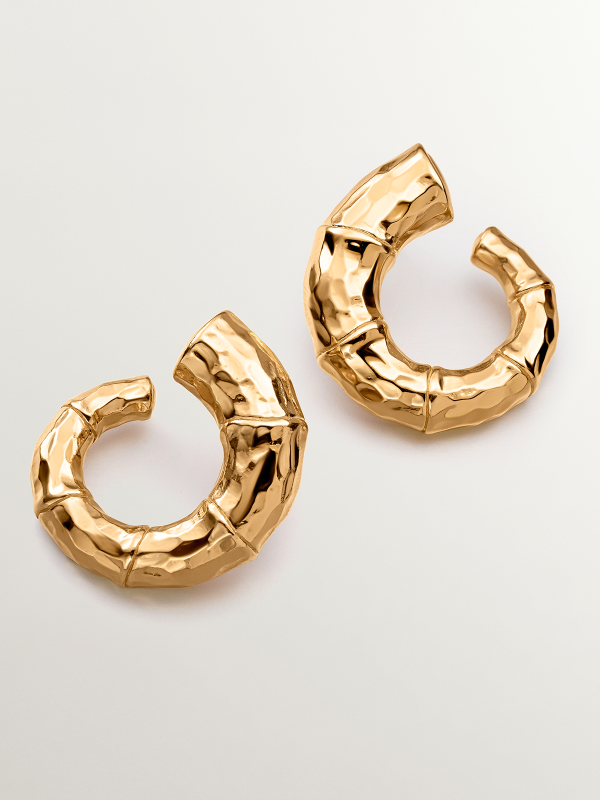 Large hoop earrings made of 925 silver, bathed in 18K yellow gold with a bamboo texture.