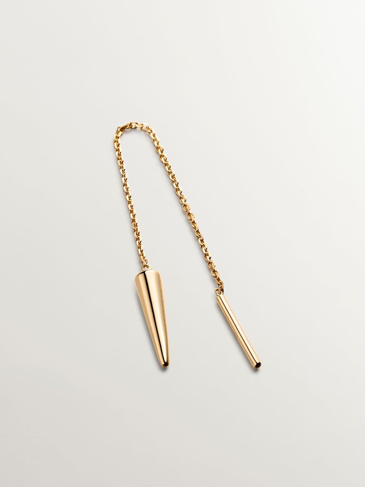 Individual 9K yellow gold earring with chain and spike.