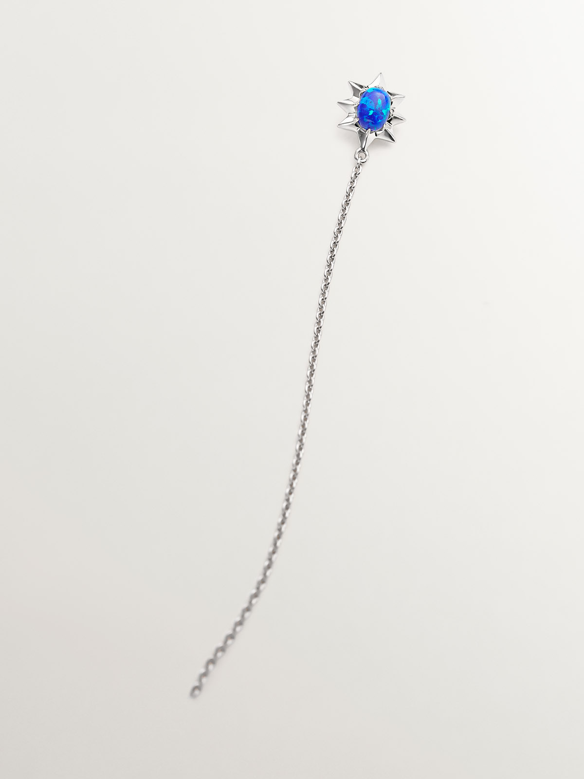 Individual 18K white gold chain earring with blue opal.
