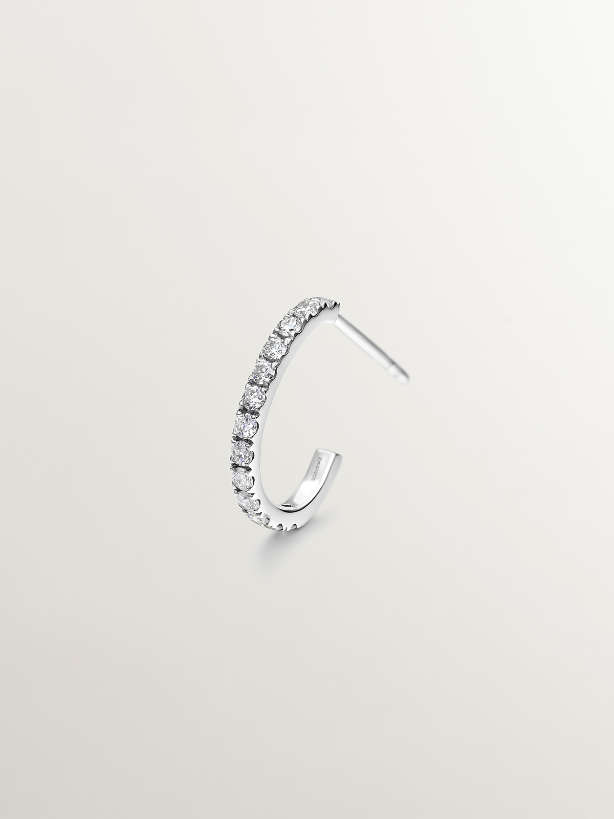 Individual small hoop earring made of 18K white gold with 0.20cts diamonds.