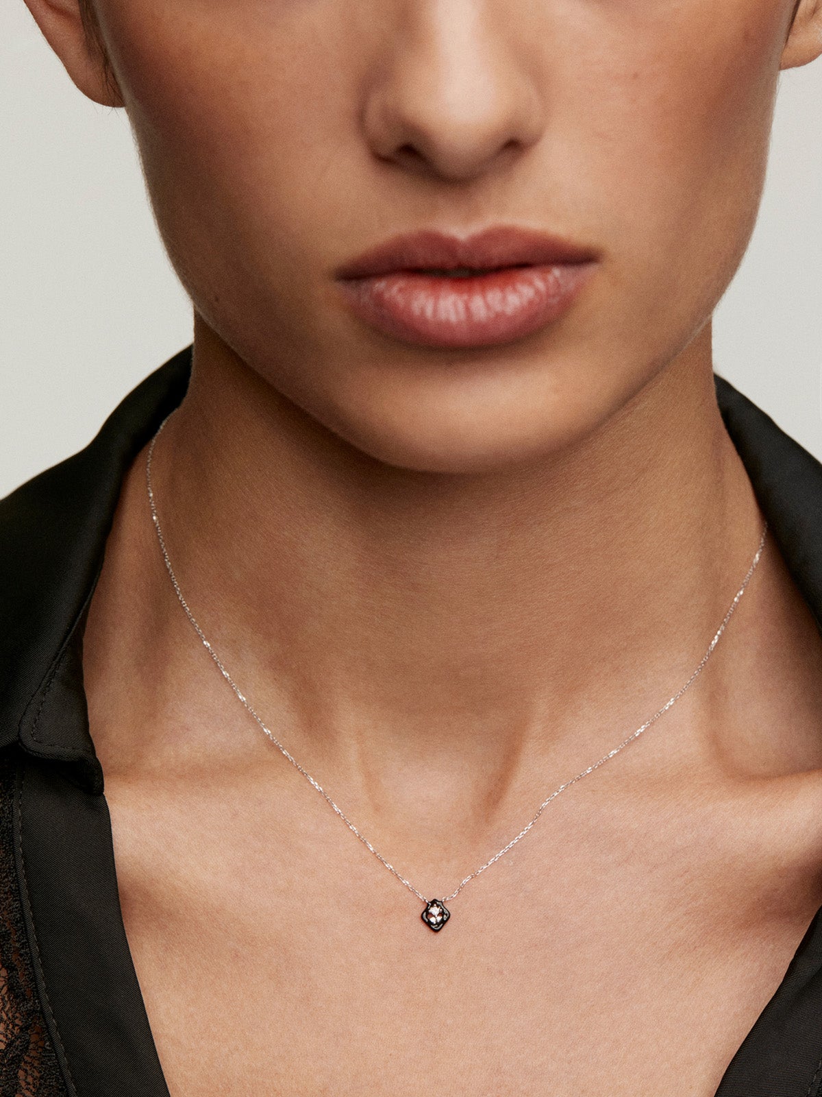 18K white gold pendant with black enamel and diamond.