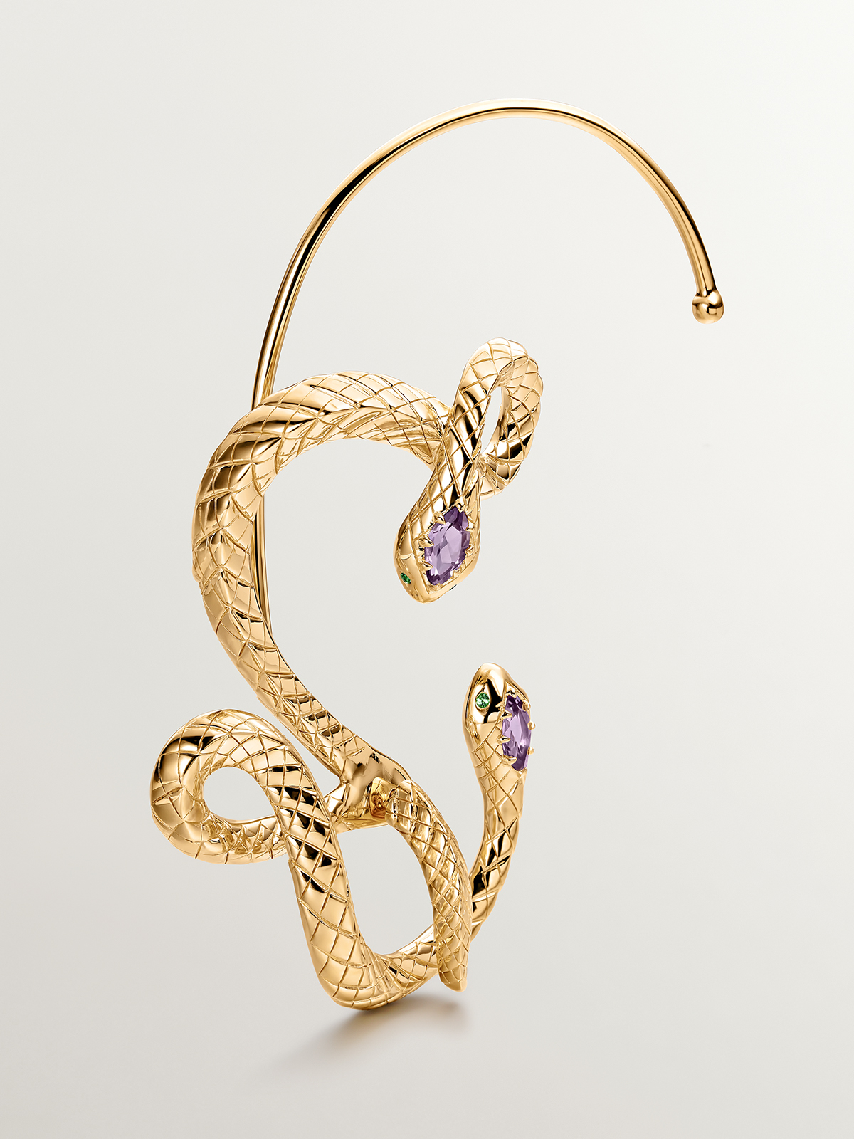 925 Sterling silver earcuff plated in 18K yellow gold with a snake design, amethyst and tsavorite.