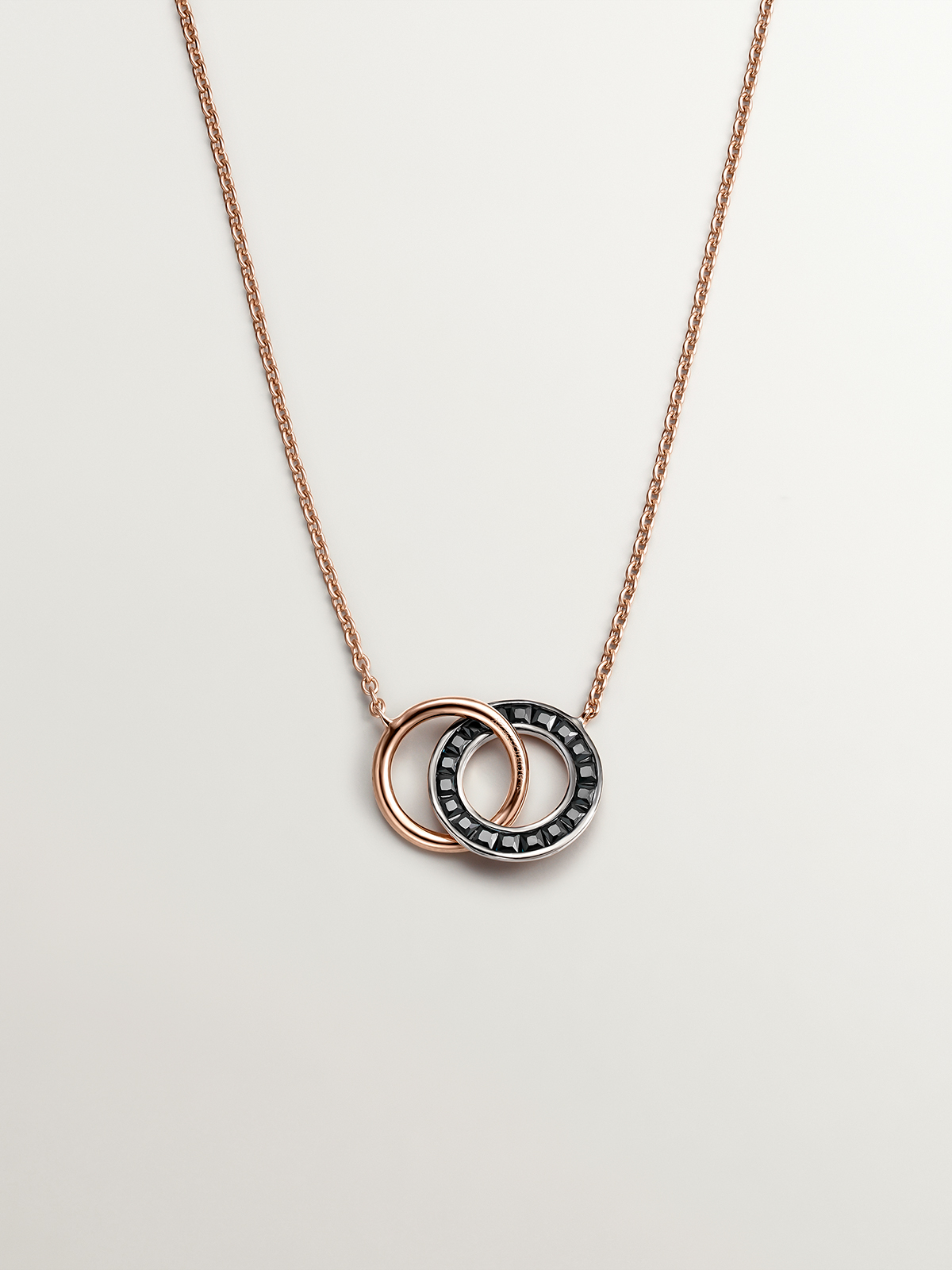 925 Silver pendant bathed in 18K rose gold with circles and black spinels.