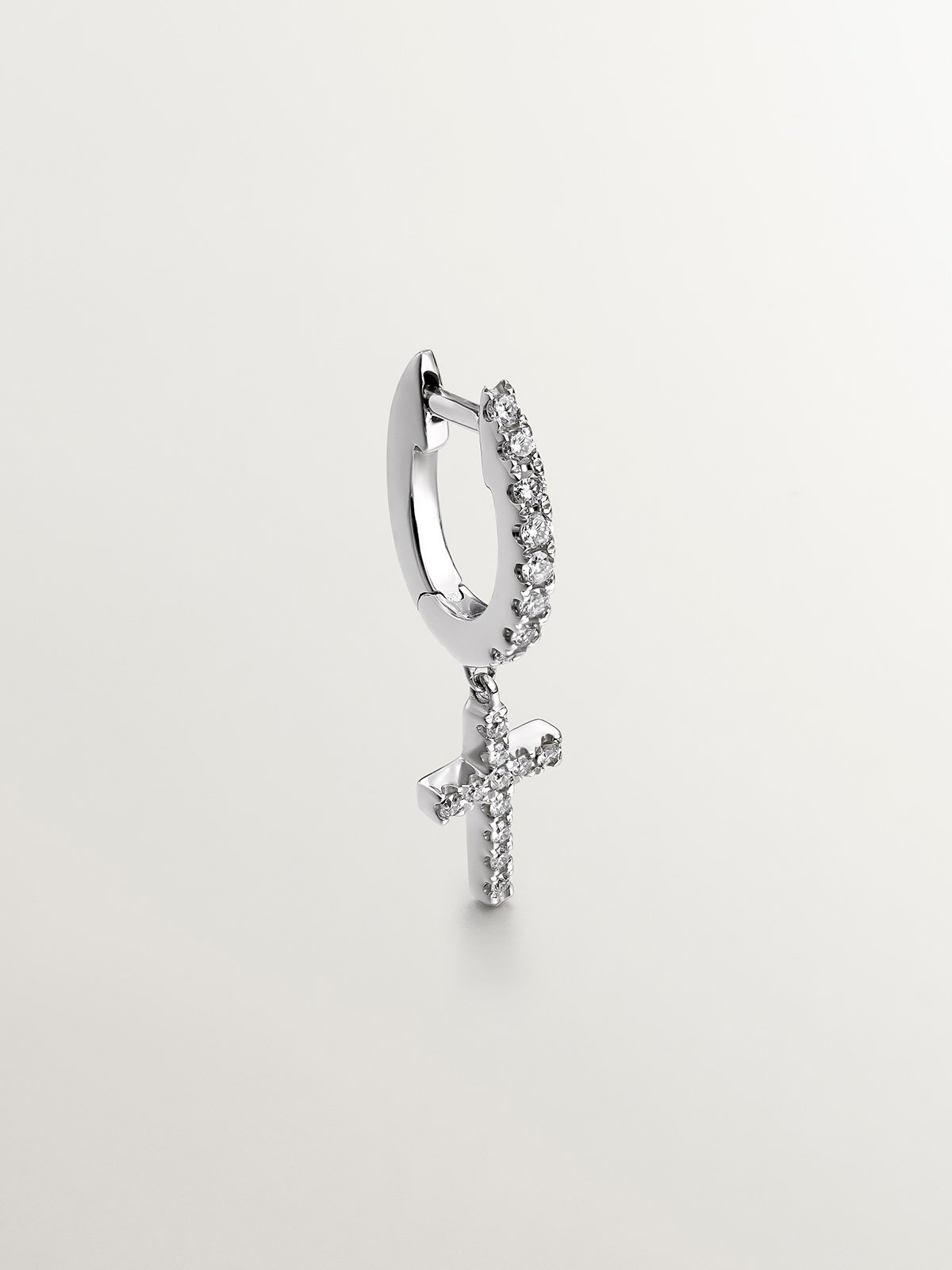 Single 18K white gold earring with diamonds and cross.