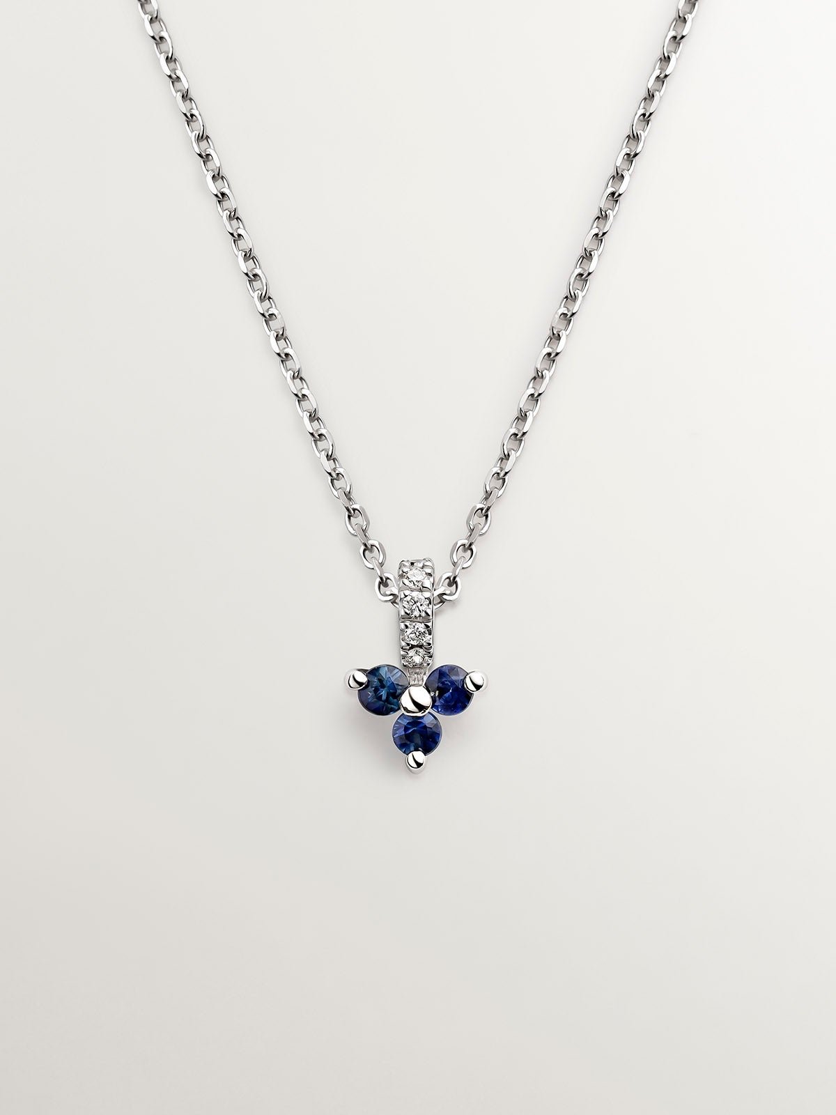 18K white gold pendant with blue sapphires and diamonds.