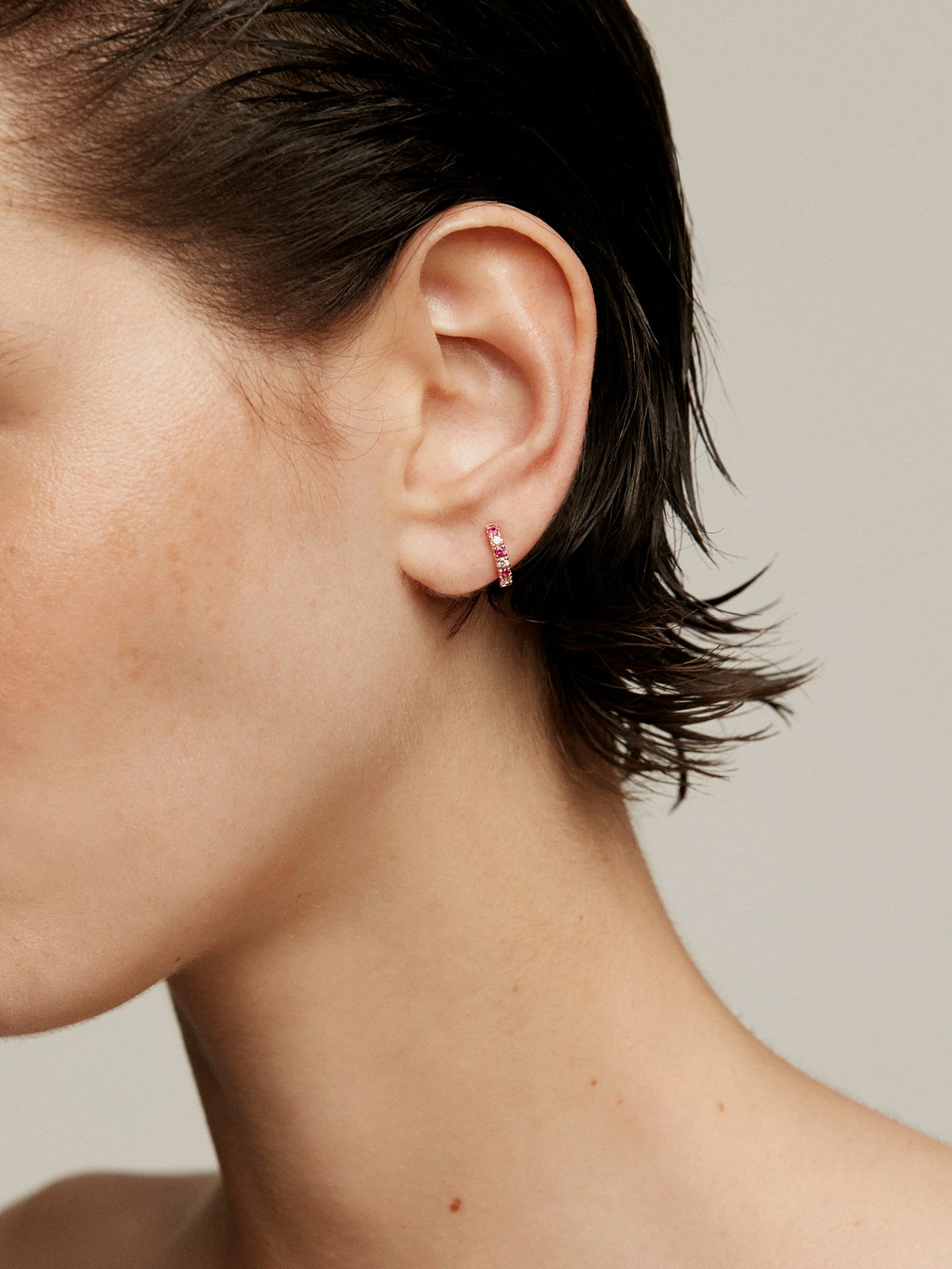 Single 9K rose gold hoop earring with rubies and diamonds.