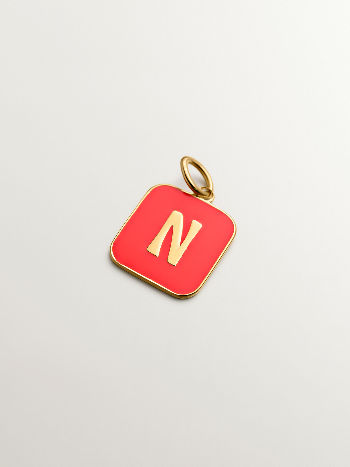 18K yellow gold plated 925 sterling silver charm with N initial and pink enamel in a square shape