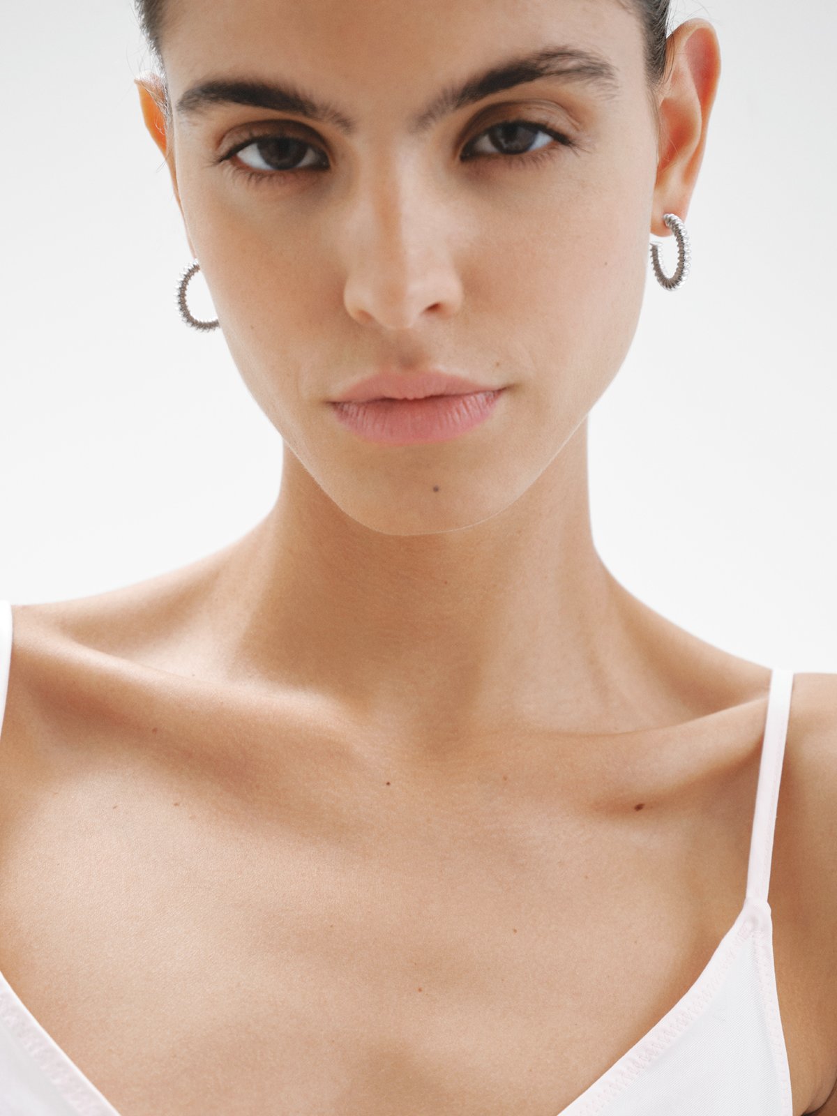 Medium size 925 silver hoop earrings with embossed finish.