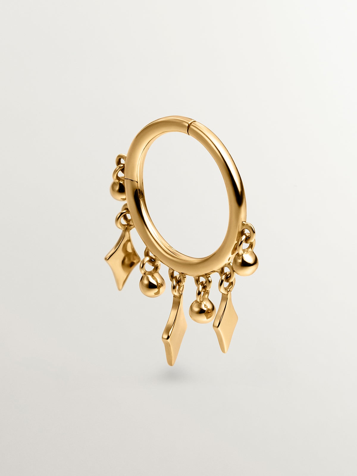 Individual 9K yellow gold hoop earring with spheres and diamonds.